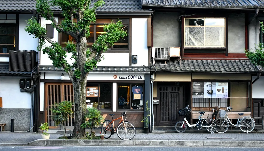 Bicycles parked in front of old wooden houses on a quiet Tokyo street