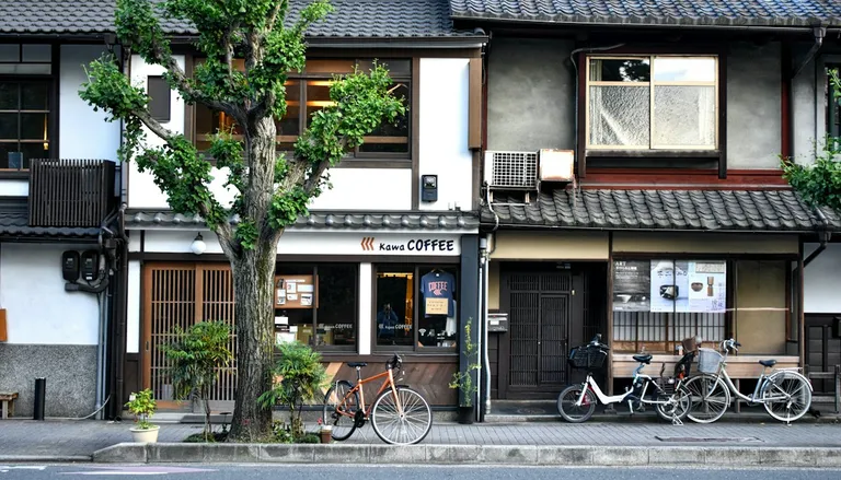 Bicycles parked in front of old wooden houses on a quiet Tokyo street