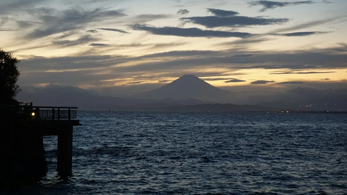Mount Fuji silhouetted across the sea at dusk, seen from Enoshima