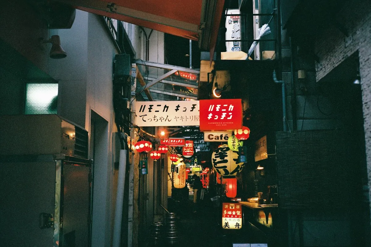 Lanterns and small bar signs in a narrow alley of Harmonica Yokocho at night