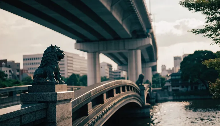 A granite arched bridge with a bronze lion statue beneath an elevated expressway in Nihonbashi