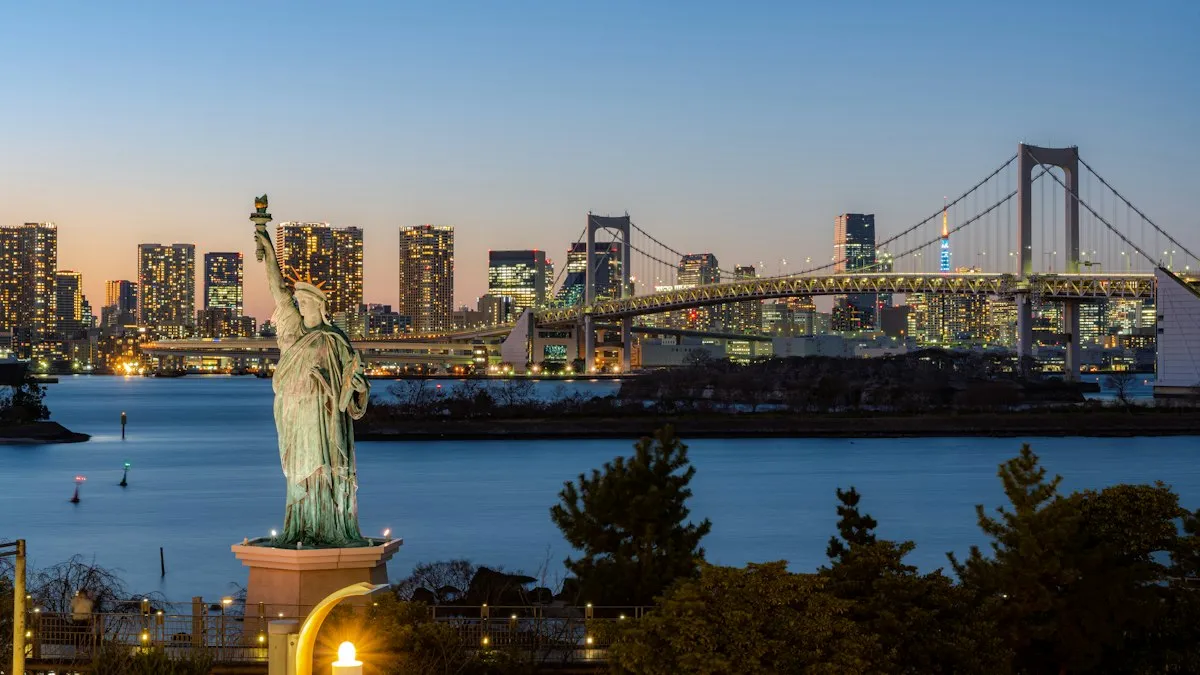 The Statue of Liberty replica in Odaiba with the Rainbow Bridge lit up at dusk