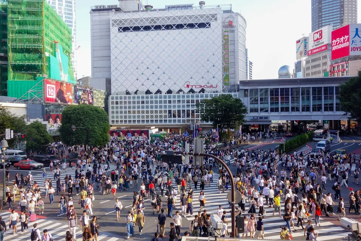Crowds crossing the road in front of Shibuya Station in the daytime