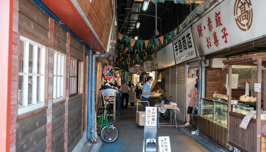 Small shops and a sweets shop along a narrow local shopping street