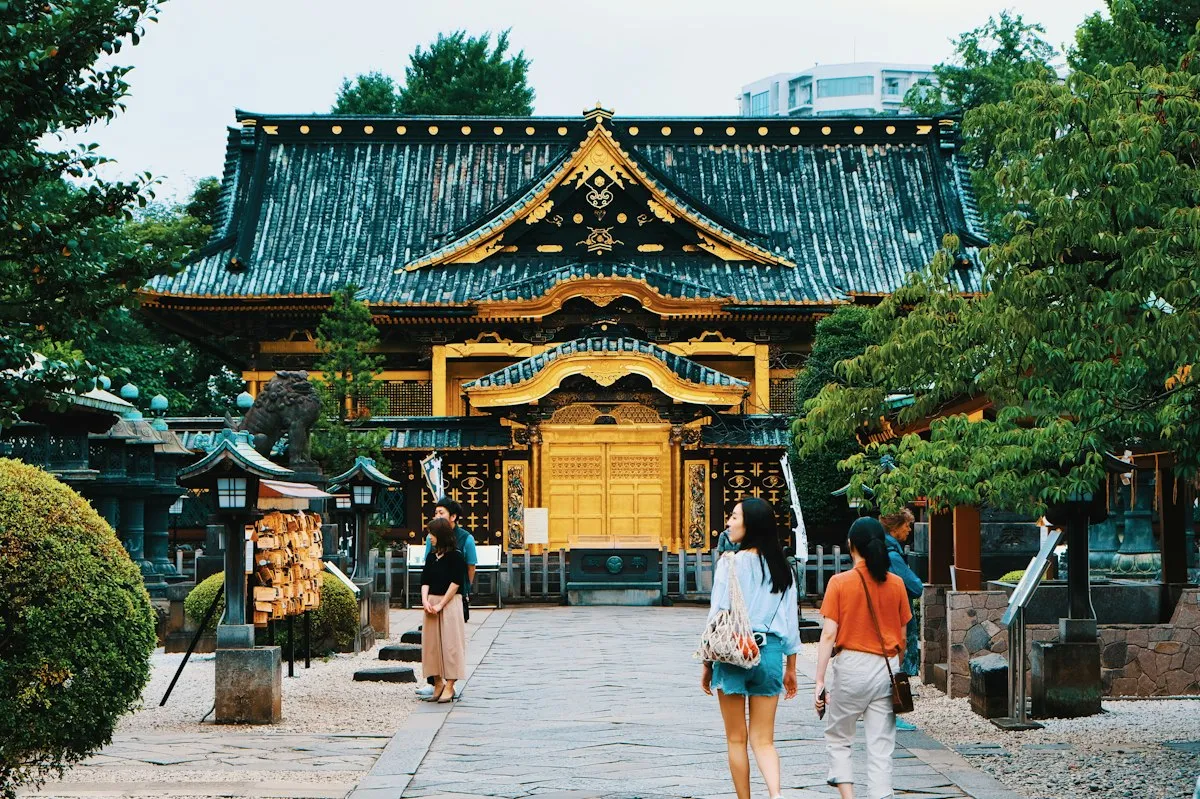 Visitors walking toward the gold-decorated hall of Ueno Toshogu Shrine in Ueno Park